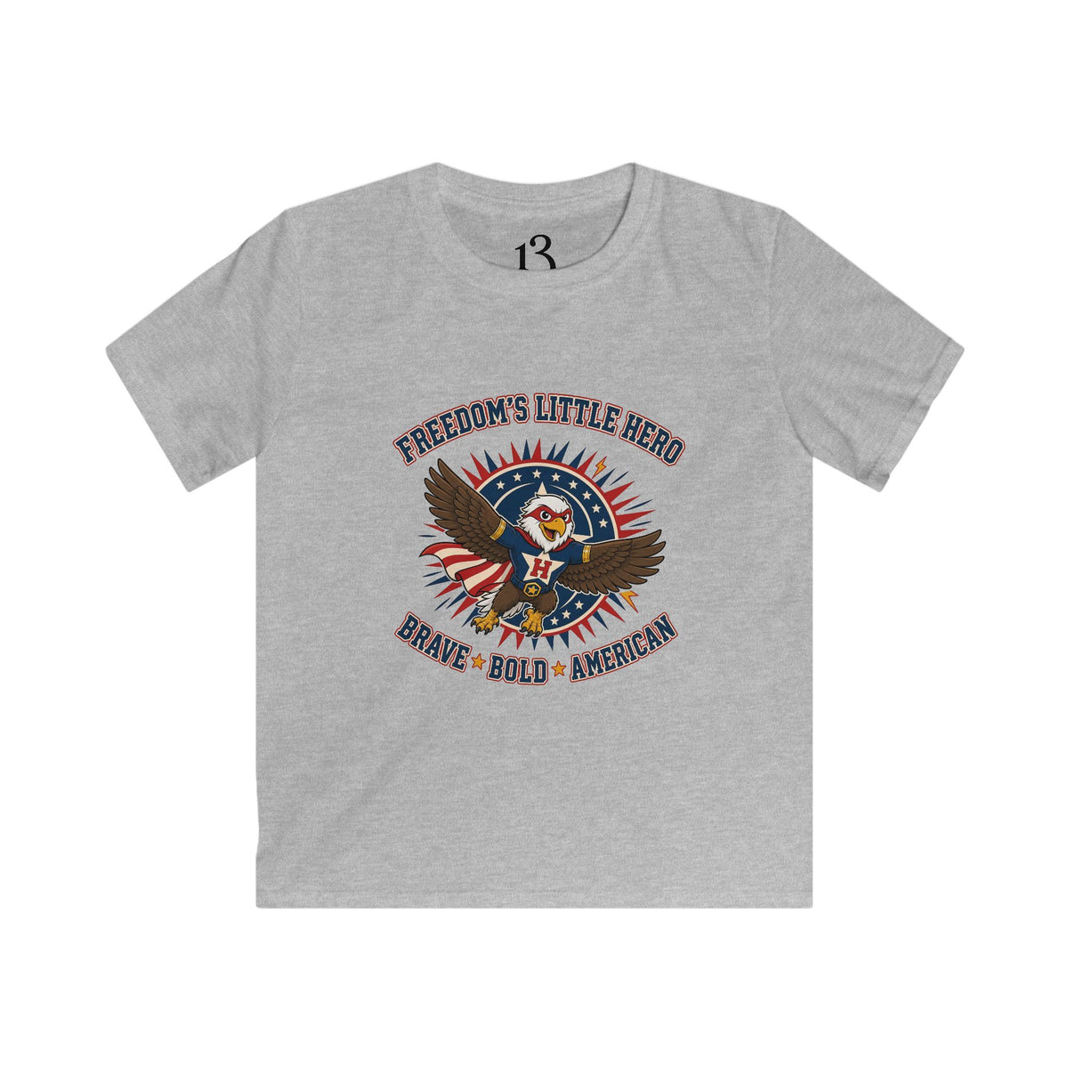 Front view of sport grey kids T-shirt with a superhero eagle and “Freedom’s Little Hero — Brave, Bold, American” lettering.