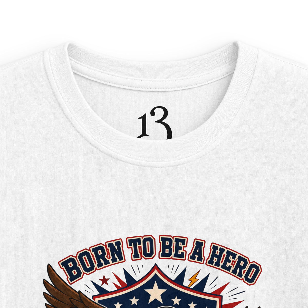 Close-up of white kids T-shirt neckline and “Born to Be a Hero” graphic.