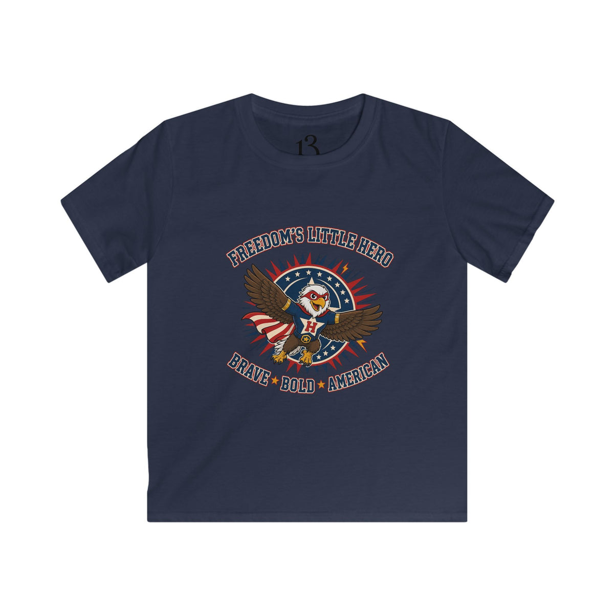 Front view of navy kids T-shirt with a superhero eagle and “Freedom’s Little Hero — Brave, Bold, American” lettering.