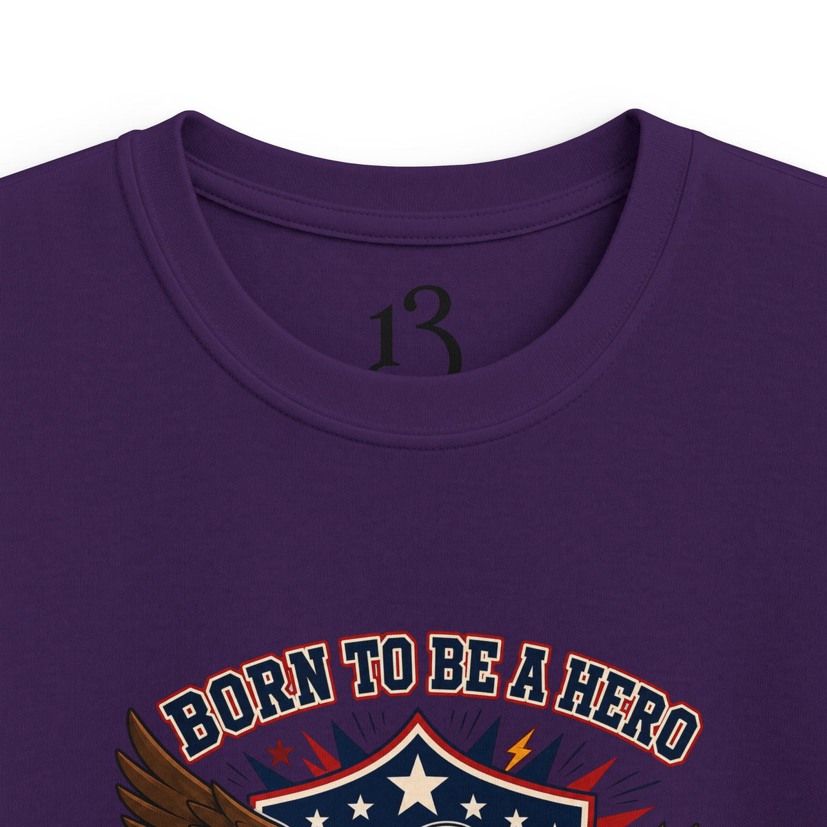 Close-up of purple kids T-shirt neckline and “Born to Be a Hero” graphic.