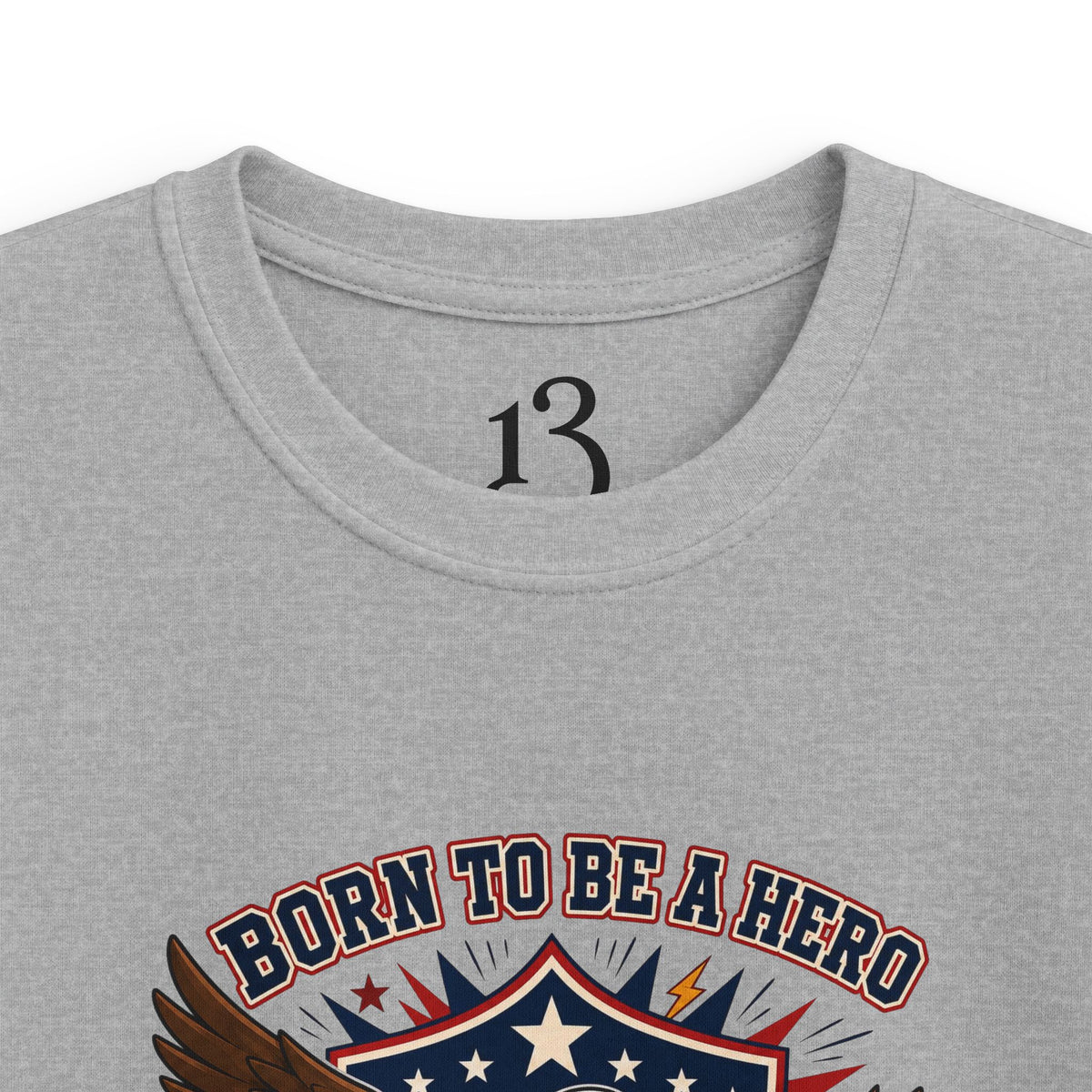 Close-up of sport grey kids T-shirt neckline and “Born to Be a Hero” graphic.