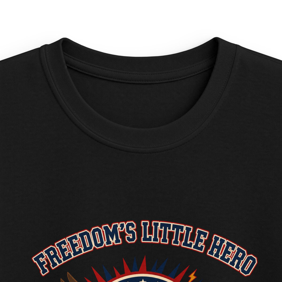 Close-up of black kids T-shirt neckline and “Freedom’s Little Hero” graphic.