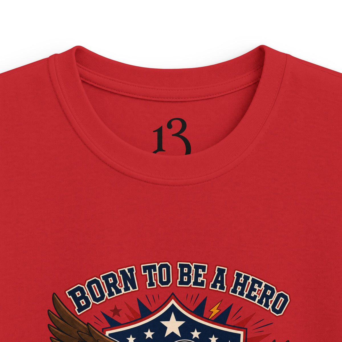 Close-up of red kids T-shirt neckline and “Born to Be a Hero” graphic.