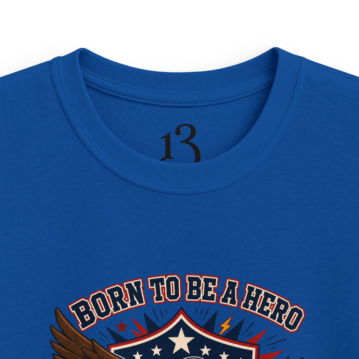 Close-up of royal blue kids T-shirt neckline and “Born to Be a Hero” graphic.