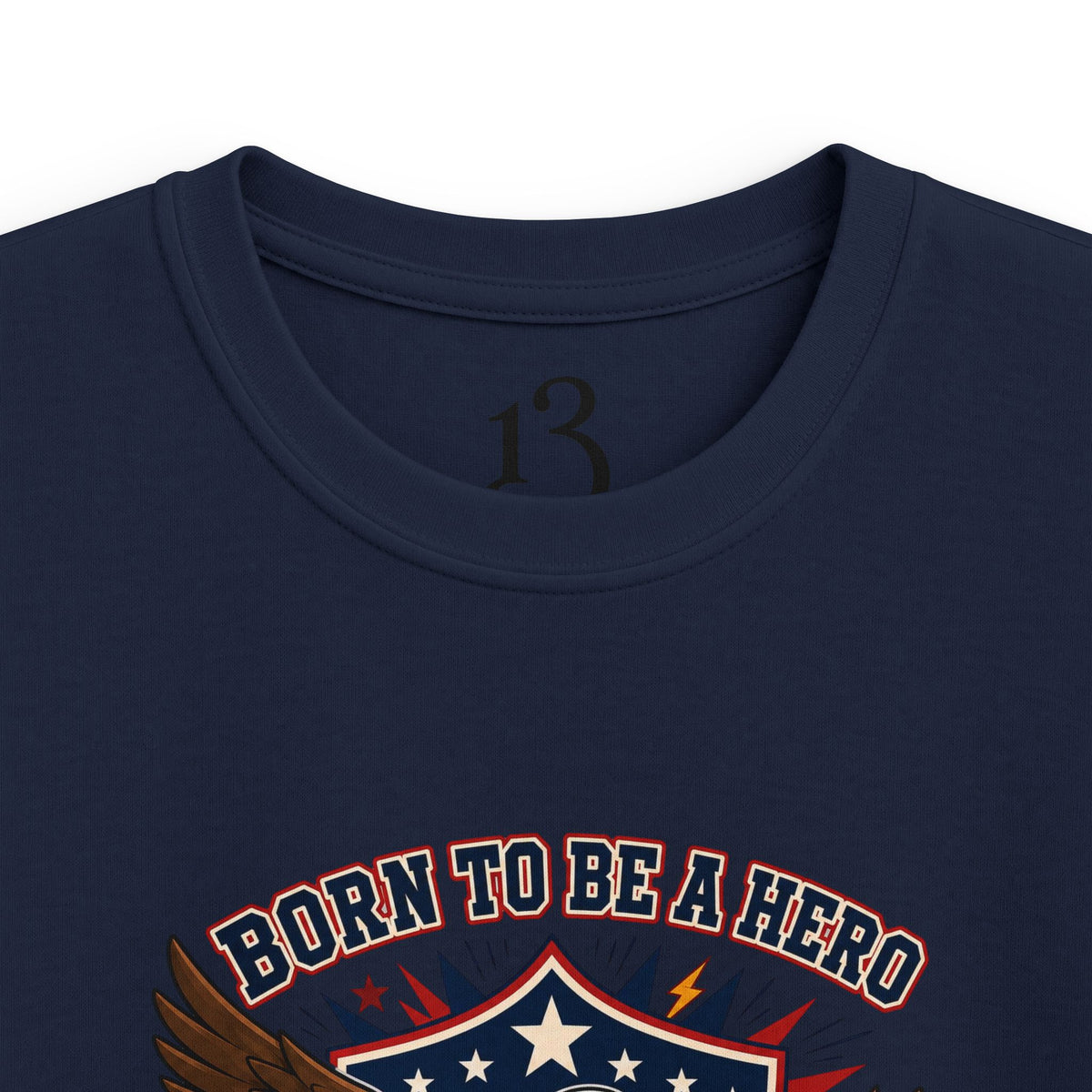 Close-up of navy kids T-shirt neckline and “Born to Be a Hero” graphic.