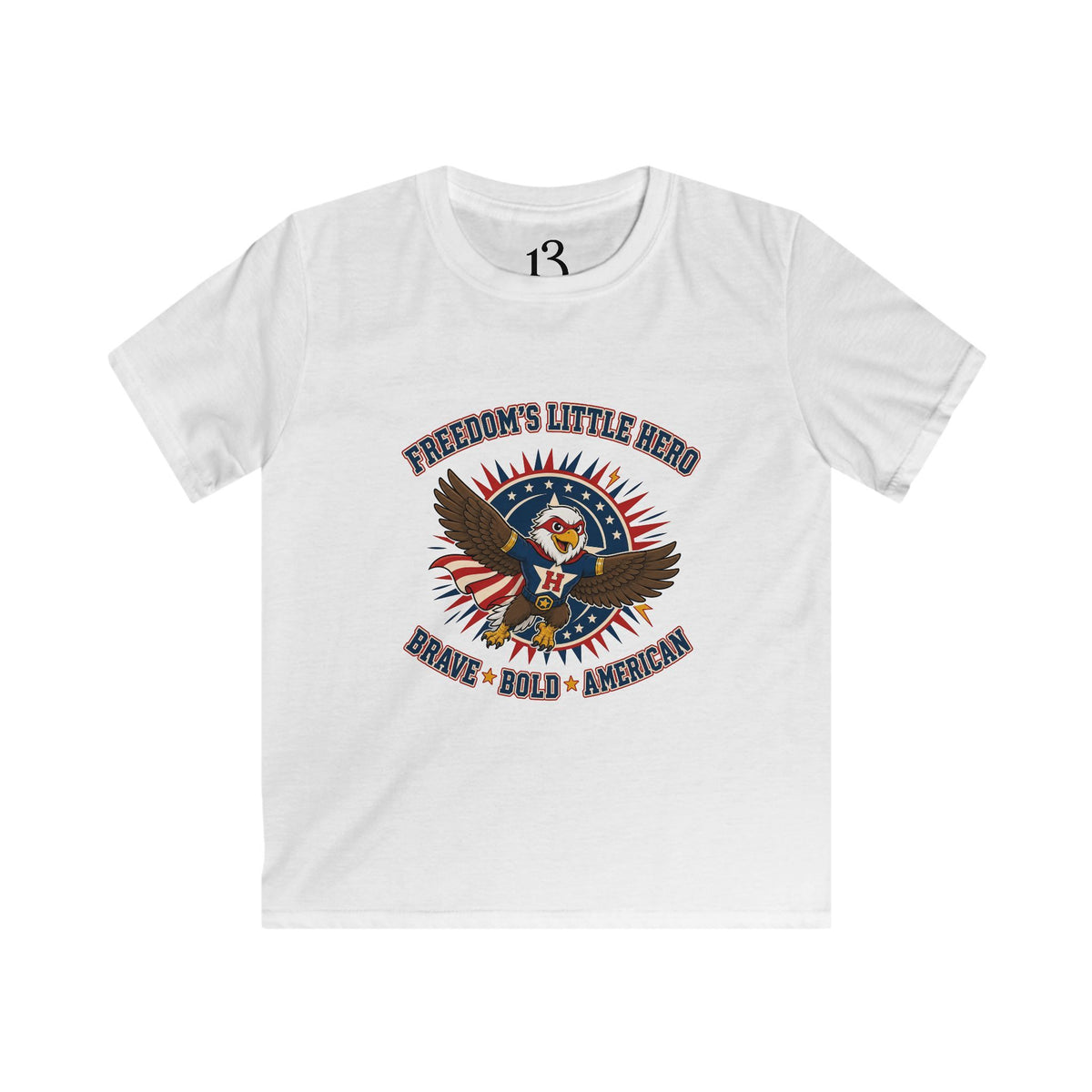 Front view of white kids T-shirt with a superhero eagle and “Freedom’s Little Hero — Brave, Bold, American” lettering.