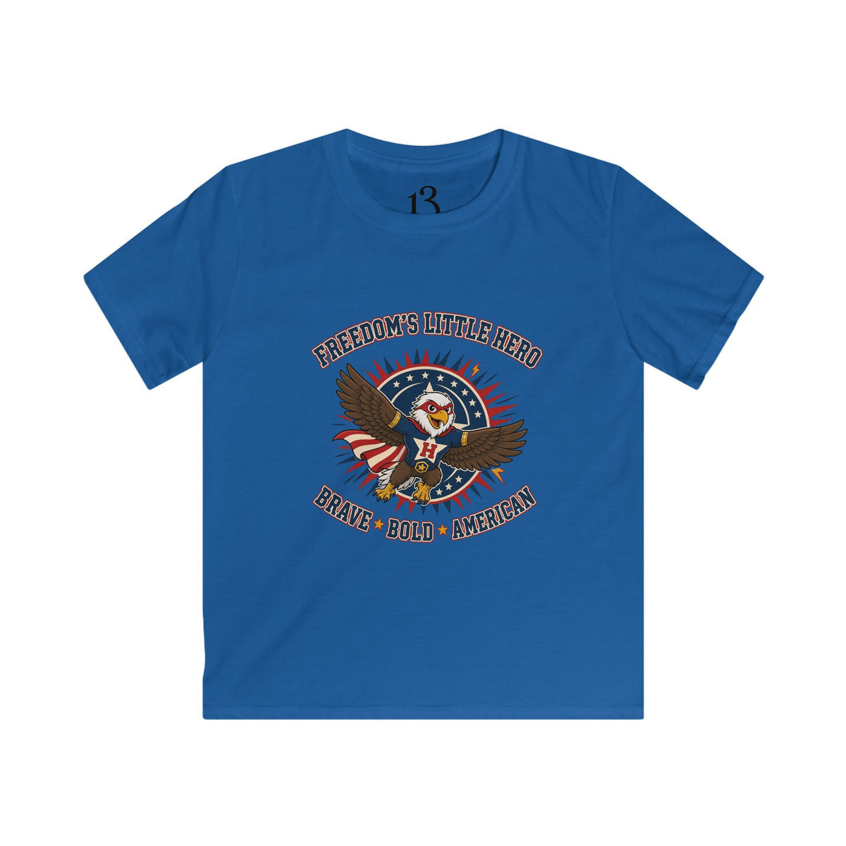 Front view of royal blue kids T-shirt with a superhero eagle and “Freedom’s Little Hero — Brave, Bold, American” lettering.