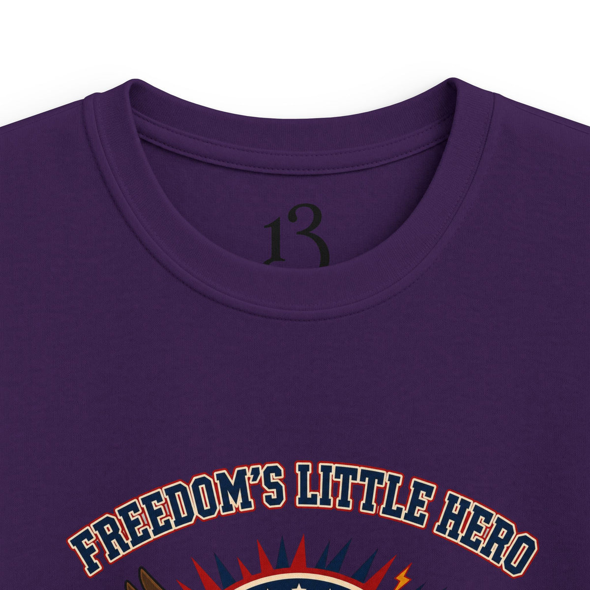 Close-up of purple kids T-shirt neckline and “Freedom’s Little Hero” graphic.